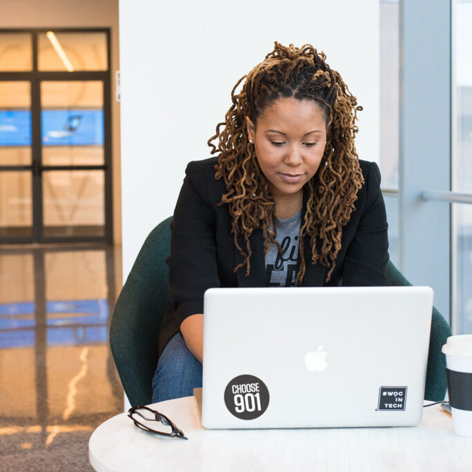 Woman looking at a computer to choose a Memphis property management company